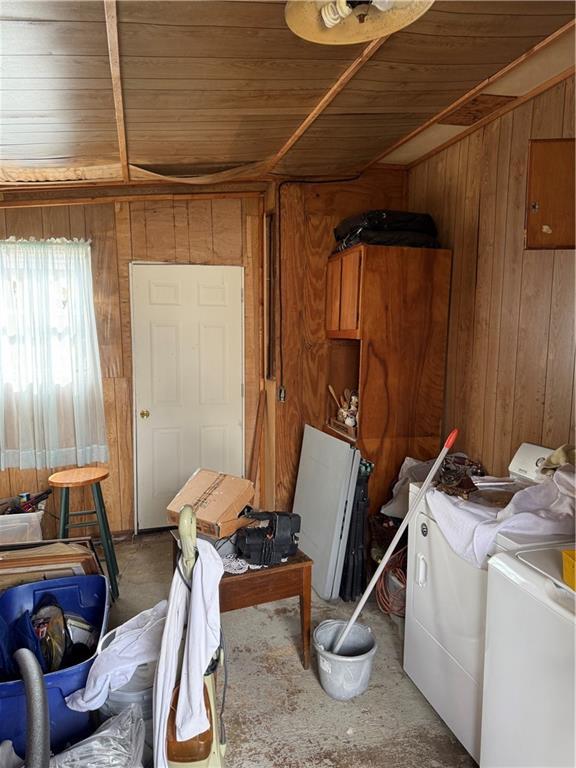 laundry area featuring independent washer and dryer, wooden walls, and wooden ceiling