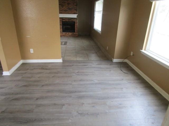 unfurnished living room featuring light hardwood / wood-style flooring and a fireplace