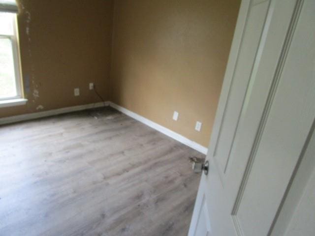 empty room with light hardwood / wood-style flooring