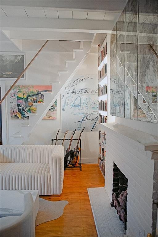 stairs with hardwood / wood-style flooring and a fireplace