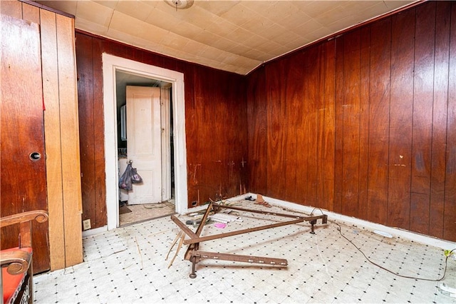 spare room featuring wood walls