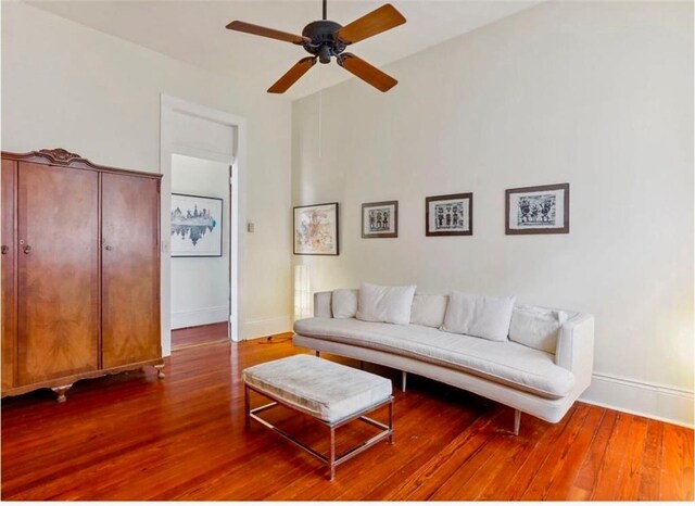 living room with wood-type flooring and ceiling fan