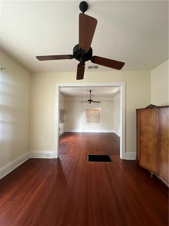 interior space with visible vents, baseboards, and wood finished floors