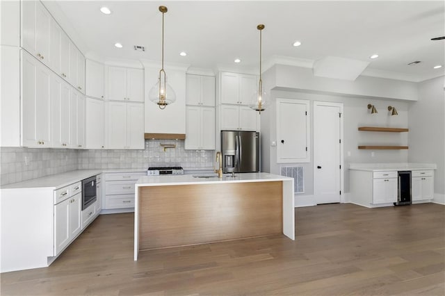 kitchen featuring white cabinetry, an island with sink, and appliances with stainless steel finishes