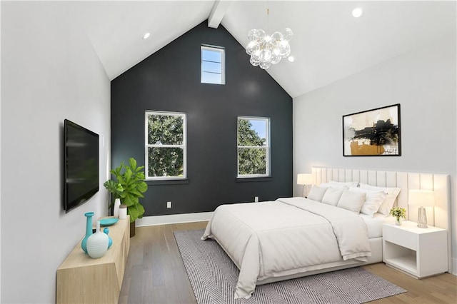 bedroom featuring an inviting chandelier, high vaulted ceiling, beam ceiling, and light hardwood / wood-style floors