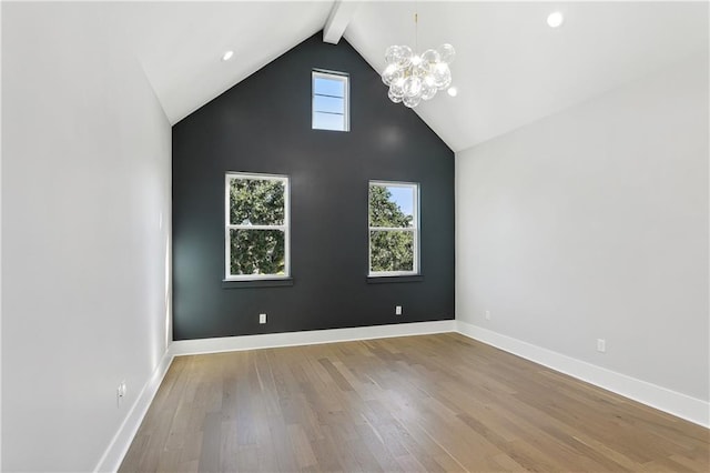 interior space with plenty of natural light, beam ceiling, and light hardwood / wood-style floors