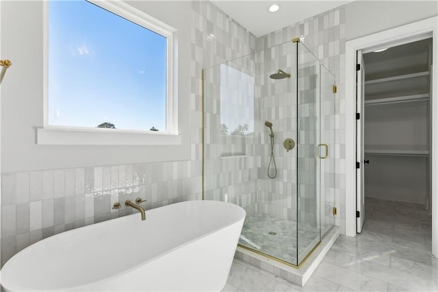 bathroom with plus walk in shower and tile walls