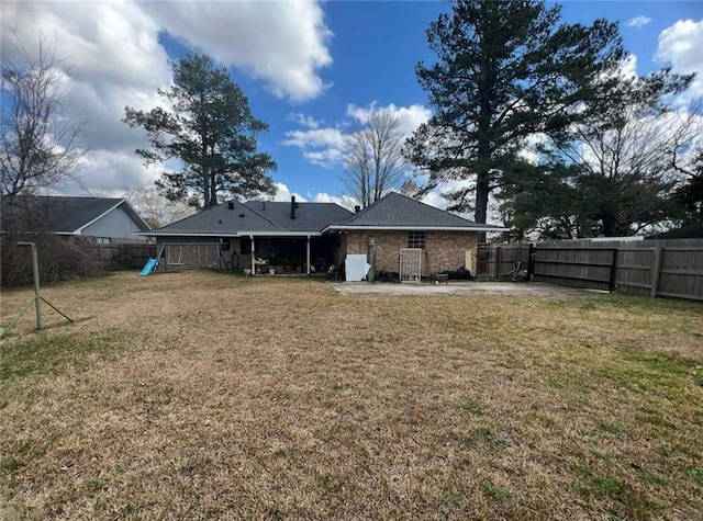 back of property with a playground, a patio, and a lawn