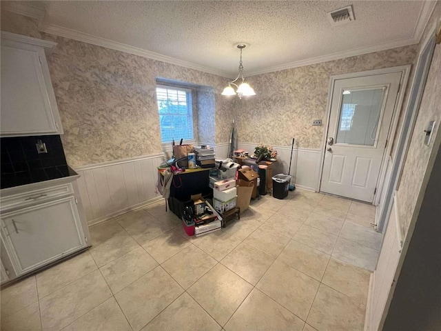 tiled dining room with crown molding, a chandelier, and a textured ceiling