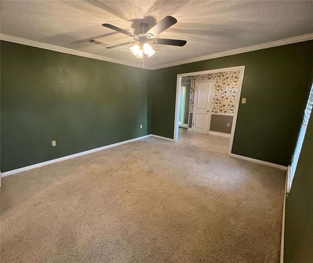 spare room with ornamental molding, carpet floors, and a textured ceiling