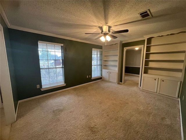 interior space with crown molding, ceiling fan, light carpet, and a textured ceiling