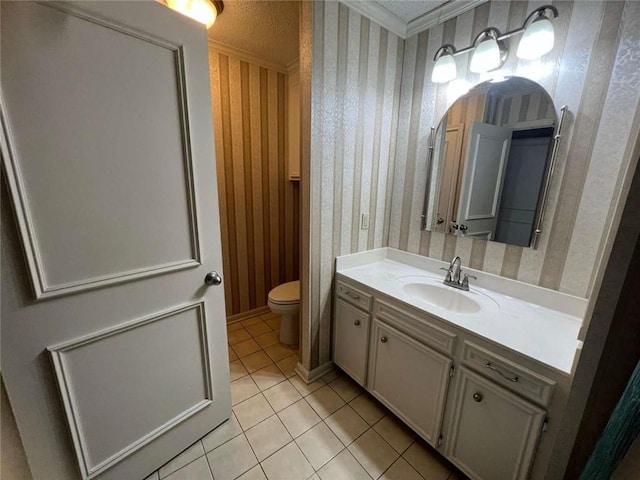 bathroom with vanity, a textured ceiling, tile patterned floors, and toilet