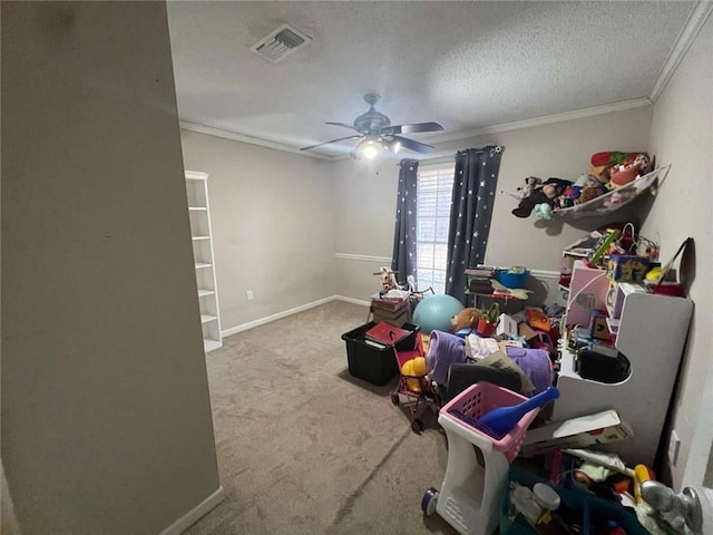 rec room with crown molding, light colored carpet, ceiling fan, and a textured ceiling