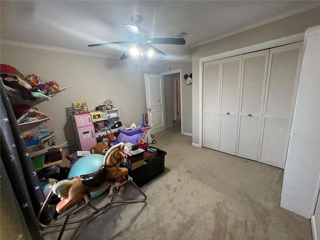 playroom featuring crown molding, ceiling fan, and carpet floors