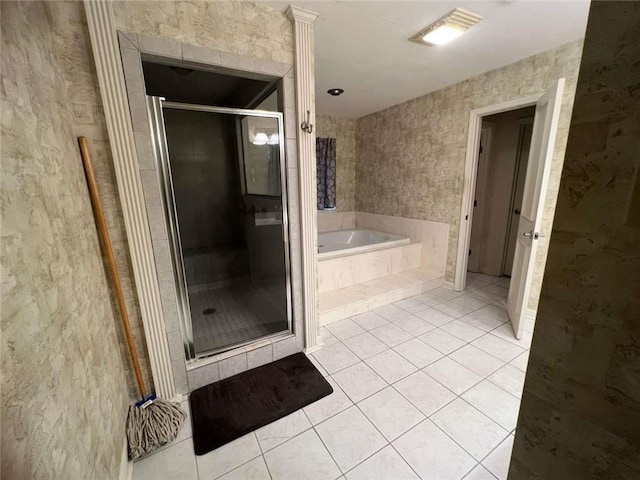 bathroom with tile patterned flooring and separate shower and tub