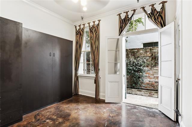 doorway to outside featuring ornamental molding and a healthy amount of sunlight