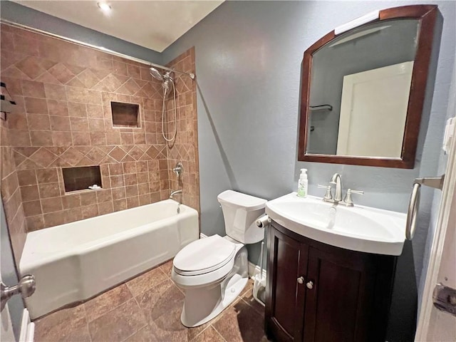 full bathroom featuring tiled shower / bath combo, vanity, and toilet