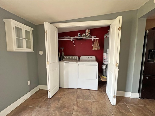 laundry area featuring tile patterned floors, separate washer and dryer, and water heater