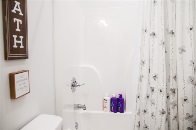 bathroom featuring shower / bath combo and toilet