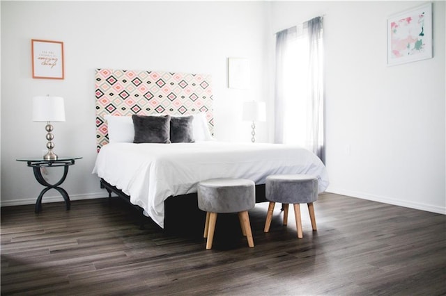 bedroom featuring multiple windows and dark hardwood / wood-style flooring