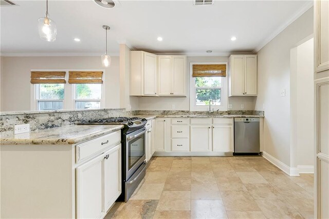 kitchen featuring pendant lighting, sink, white cabinets, stainless steel appliances, and light stone countertops