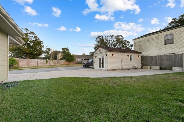 view of yard with an outdoor structure and a patio area