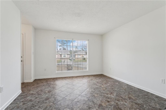 spare room with a textured ceiling