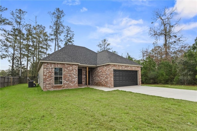 view of front of home with a garage, central AC unit, and a front lawn