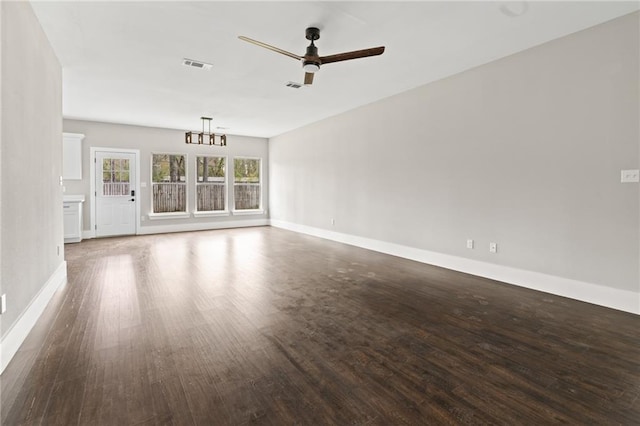 unfurnished living room featuring ceiling fan with notable chandelier and dark wood-type flooring