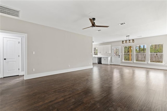 unfurnished living room featuring ceiling fan, a wealth of natural light, and dark hardwood / wood-style flooring