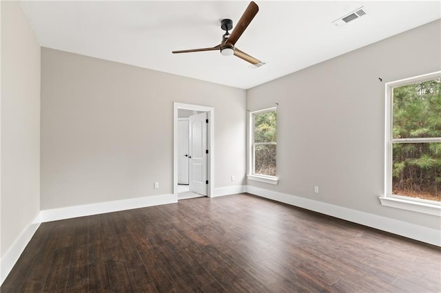 spare room featuring dark wood-type flooring and ceiling fan