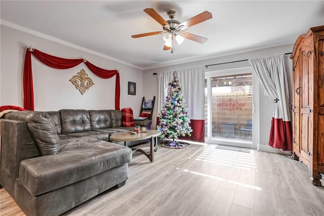 living room featuring crown molding, ceiling fan, and light hardwood / wood-style floors