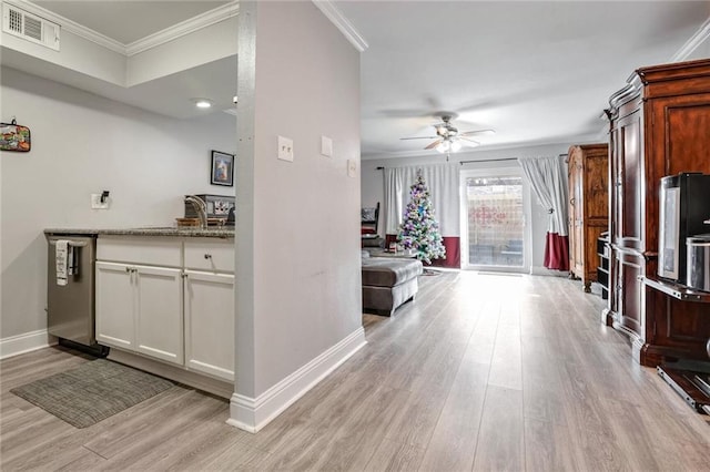 kitchen featuring dishwasher, white cabinetry, ceiling fan, crown molding, and light wood-type flooring