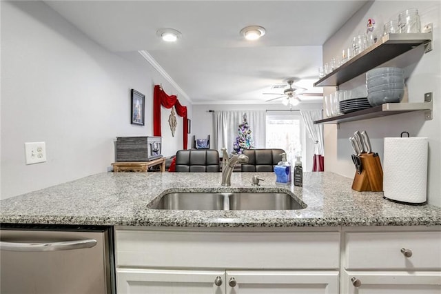 kitchen with dishwasher, white cabinetry, sink, light stone counters, and crown molding