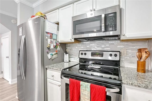 kitchen with white cabinetry, light stone counters, crown molding, and appliances with stainless steel finishes