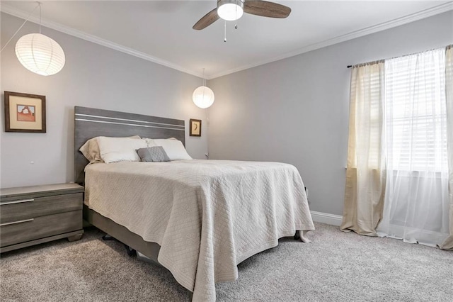 bedroom featuring ceiling fan, ornamental molding, and carpet floors