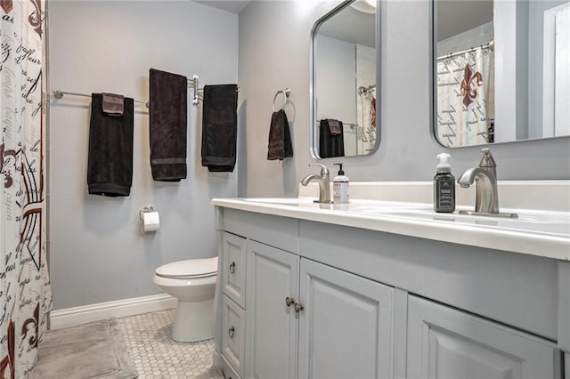 bathroom with tile patterned flooring, vanity, and toilet