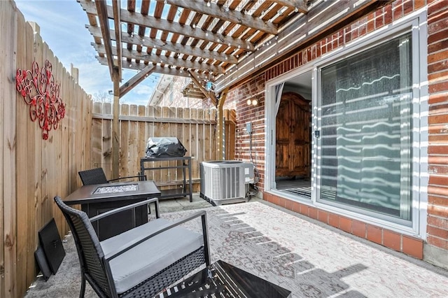 view of patio / terrace featuring an outdoor fire pit, central AC unit, and a pergola