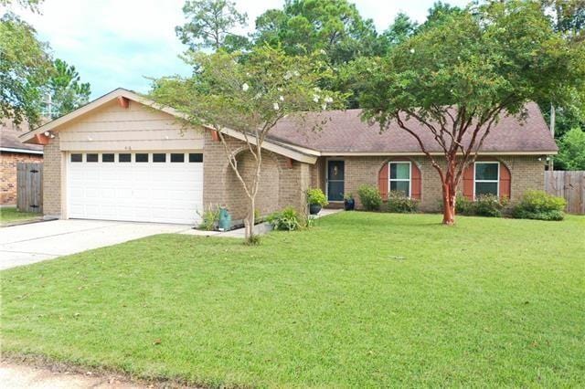 single story home with a garage and a front yard