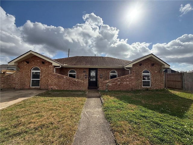 ranch-style home featuring a front yard