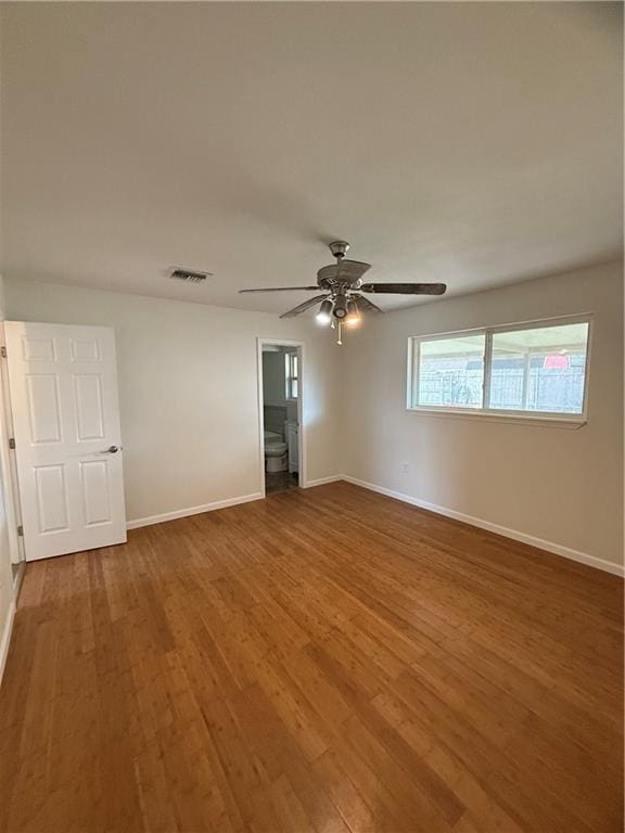 unfurnished room featuring hardwood / wood-style floors and ceiling fan