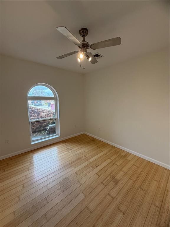 spare room featuring ceiling fan and light hardwood / wood-style flooring