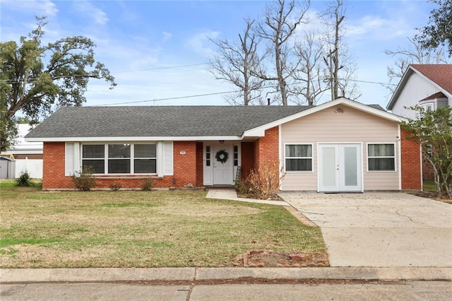 ranch-style house featuring a front lawn, french doors, brick siding, and a shingled roof