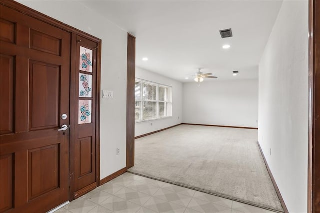 carpeted foyer entrance with ceiling fan