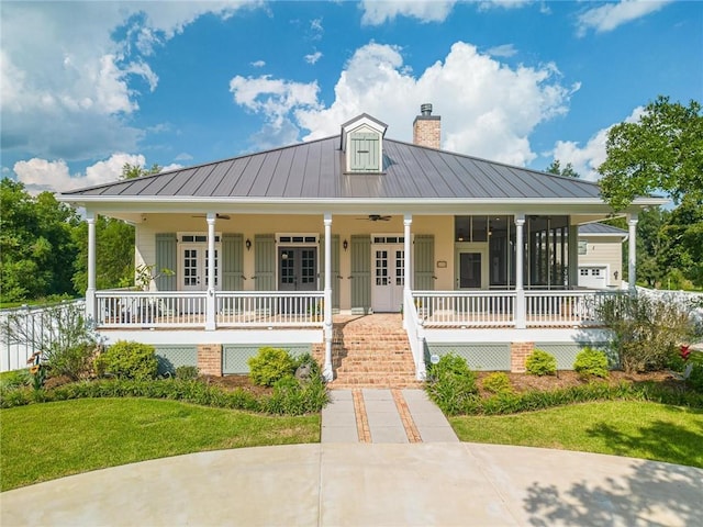 country-style home with ceiling fan, a front yard, covered porch, and french doors