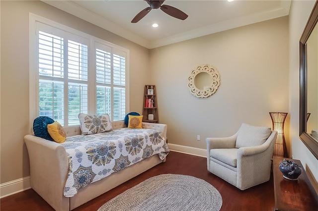 bedroom with crown molding, dark hardwood / wood-style floors, and ceiling fan