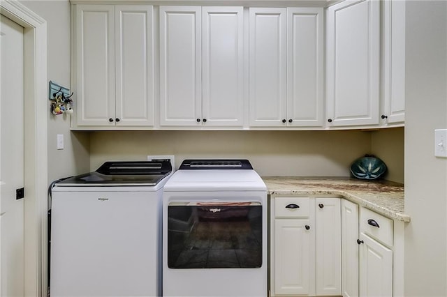 laundry room featuring cabinets and washing machine and dryer