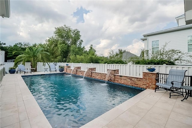 view of pool with pool water feature and a patio area