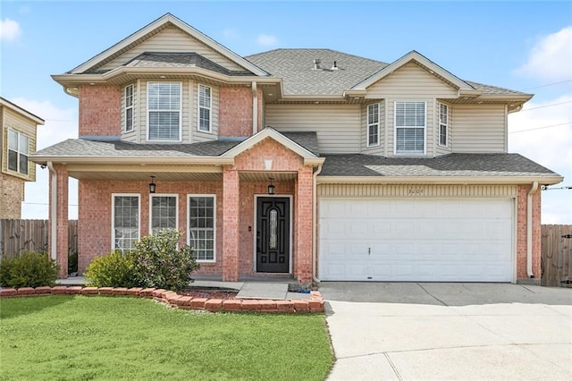 view of front of property with a garage and a front lawn