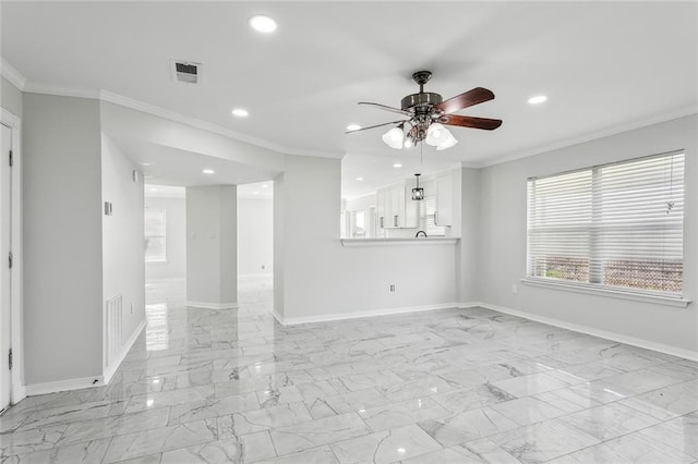 spare room with ornamental molding and ceiling fan